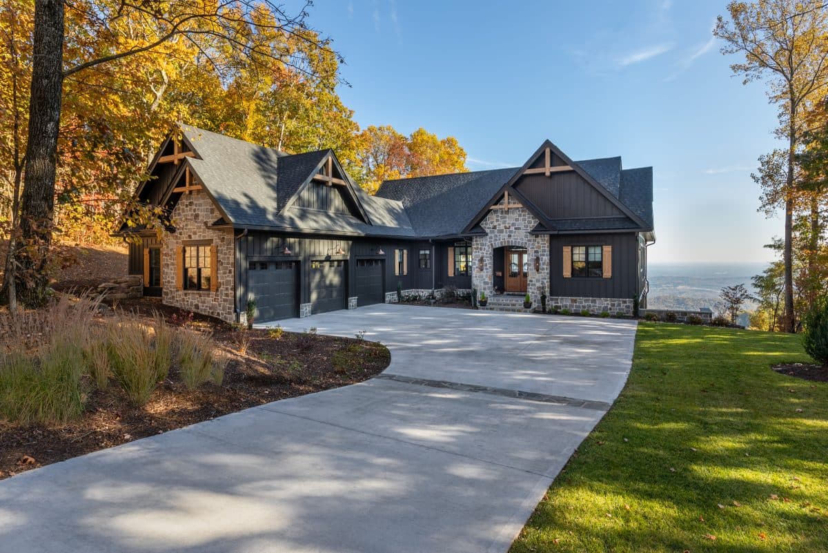 Stone and timber home surrounded by autumn trees